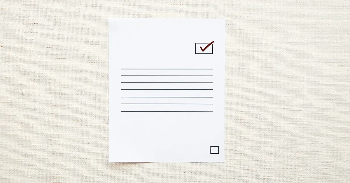 Insurance policy document and coverage verification checkmark at claims intake